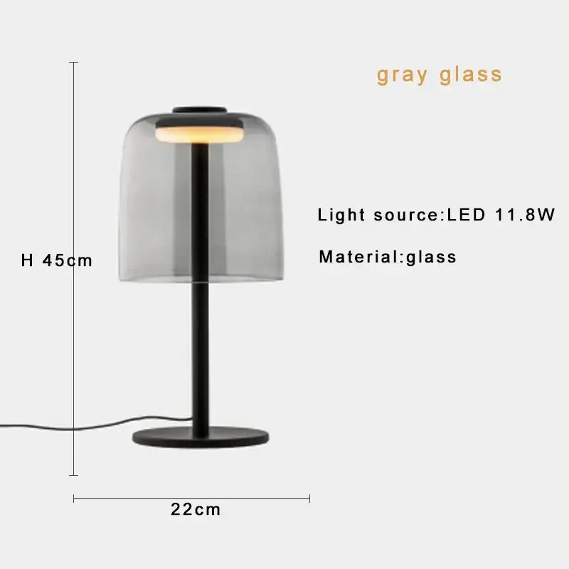 Modern green glass table lamp with sleek black stand and translucent gray dome housing led bulb for bedroom use