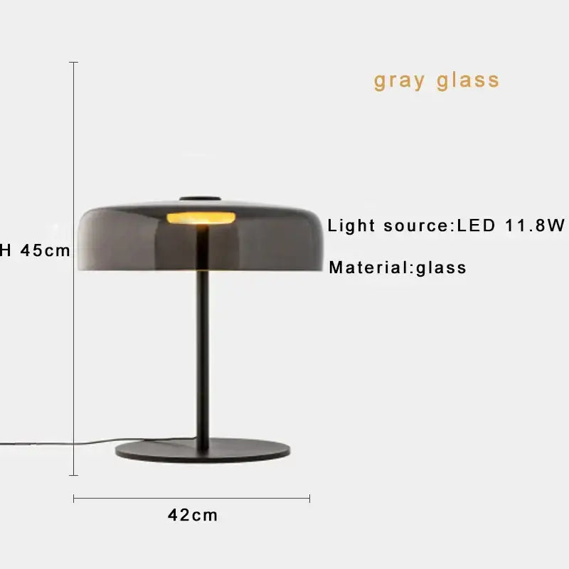 A modern table lamp with a gray glass dome and black metal base ideal as a green glass table lamp for bedroom use