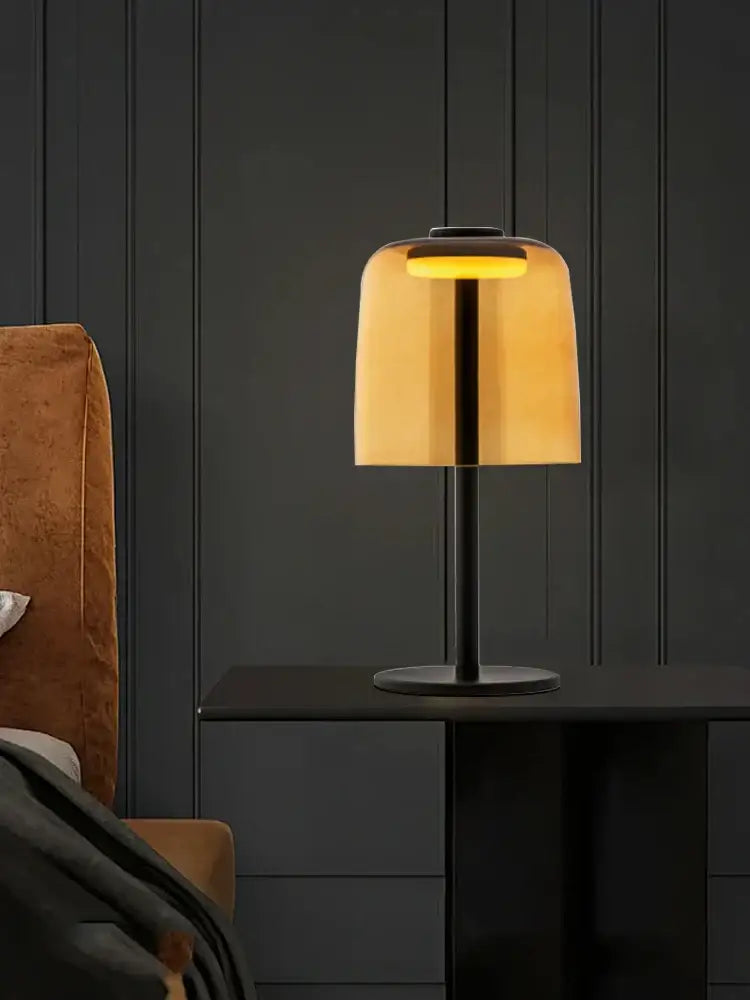 Modern green glass table lamp with warm amber shade and sleek black metal base for bedroom use with led bulb