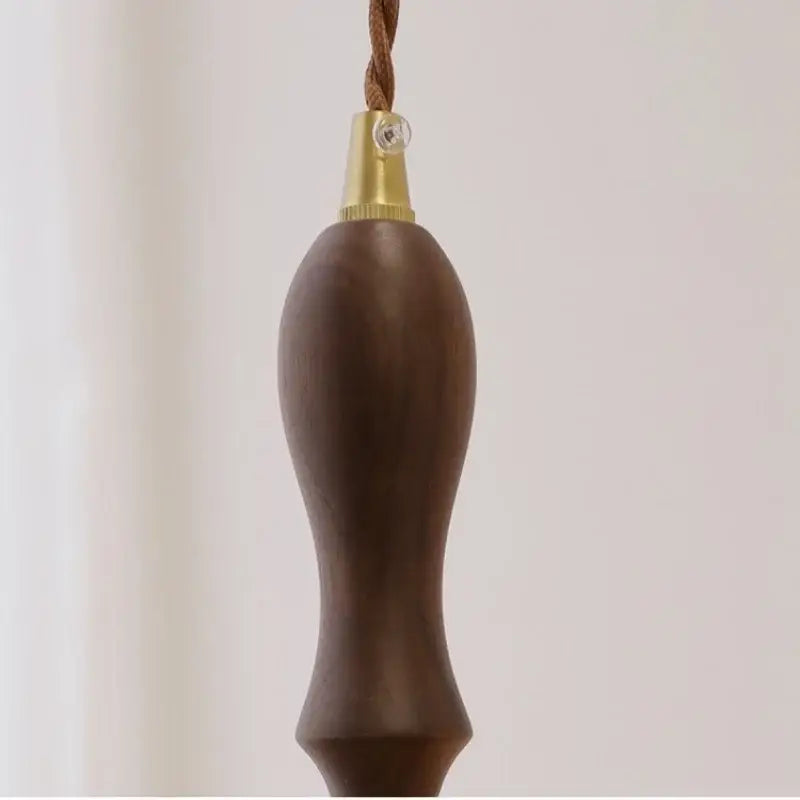 Dark brown wooden pull chain with brass cap and braided cord for modern green glass walnut wood pendant light dining room