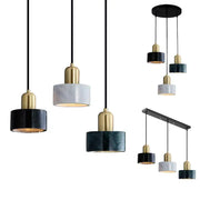 Modern pendant light with sleek black and gold fixtures and green marble cylindrical shades for dining room decorbites green marble