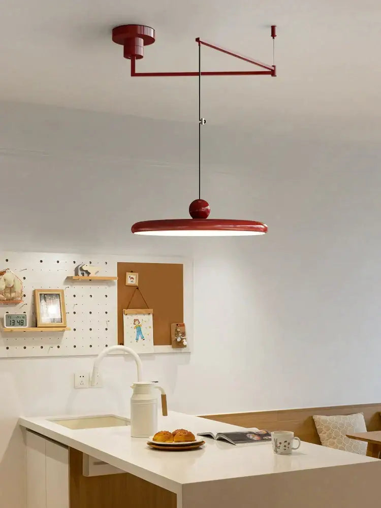 A modern red colorful metal led pendant light with a sleek circular lampshade for kitchen decorbites pendant lights