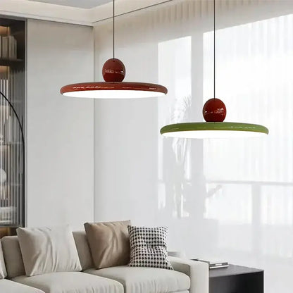 Two modern pendant light fixtures with glossy red tops and cream wind saucer shades for dining room decorbites cream wind