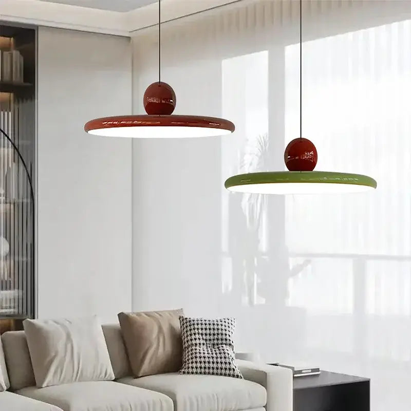 Two modern pendant light fixtures with glossy red tops and cream wind saucer shades for dining room decorbites cream wind