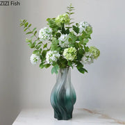 A modern decorbites green ripple glass vase in teal with hydrangeas and eucalyptus for living room decor