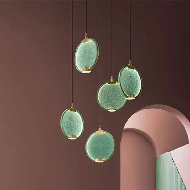 Five modern pendant lights with translucent green textured glass shades and decorbites brass pendant fixtures for dining room decor