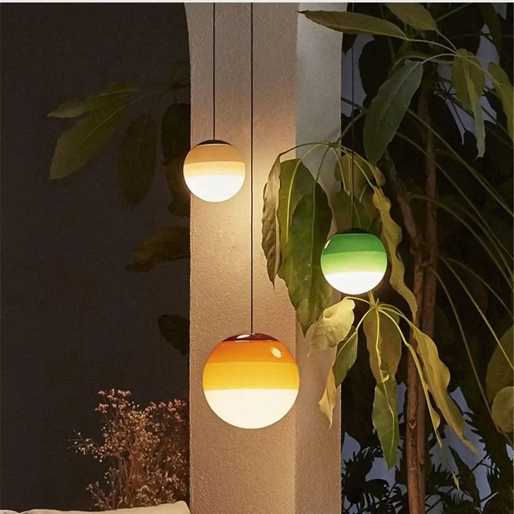 Modern green and white glass ball led pendant with gradient finish hangs against textured wall for dining room decorbites glass ball lighting