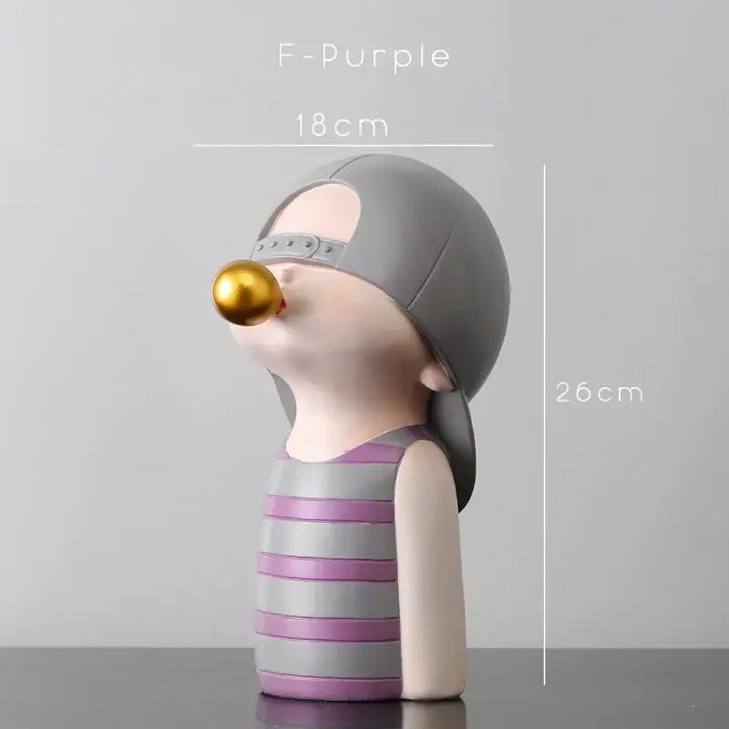 Modern green and white polka dot bubble gum blowing statue featuring a whimsical person blowing a golden bubble for living room decor