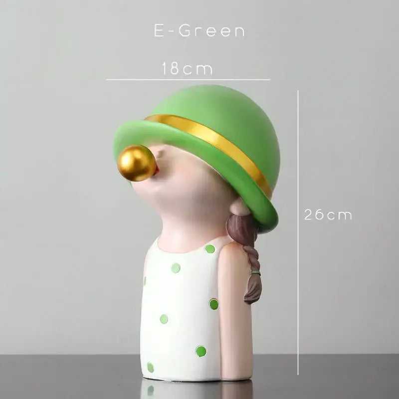 Modern green and white polka dot bubble gum blowing statue with braided hair and gold hat for living room decor