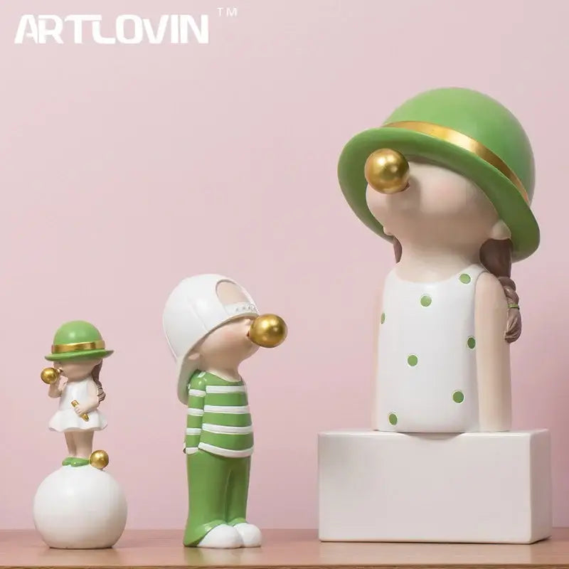 Modern green and white polka dot bubble gum blowing statue wearing a green hat with gold trim for living room decor