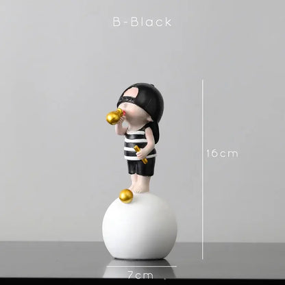 Modern green and white polka dot bubble gum blowing statue with black and white striped figurine holding golden objects