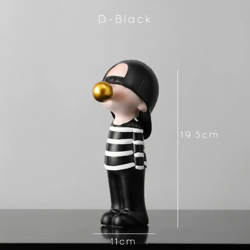 Modern green and white polka dot bubble gum blowing statue featuring a black and white striped figurine with glossy gold bubble