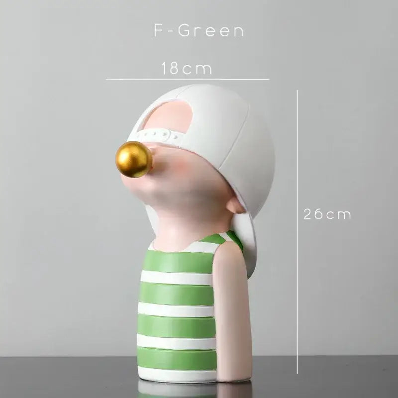 Modern green and white polka dot bubble gum blowing statue of a boy figurine with a gold bubble gum ball for living room decor