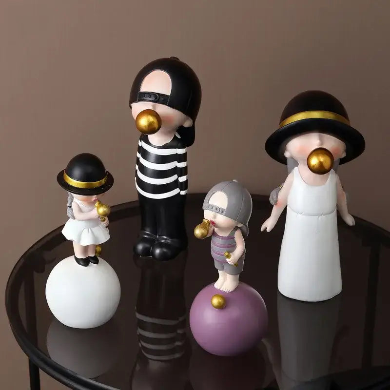 Set of four whimsical green and white polka dot resin bubble gum blowing statues with black hats for living room decor