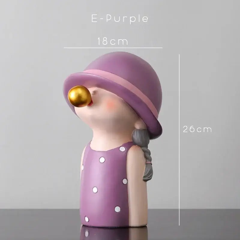 Modern green and white polka dot bubble gum blowing statue featuring a purple figurine with a pink hat band and gold bubble