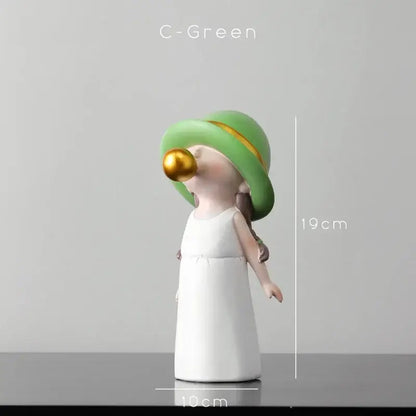 A modern green and white polka dot bubble gum blowing statue featuring a glossy figurine in a green hat and white dress
