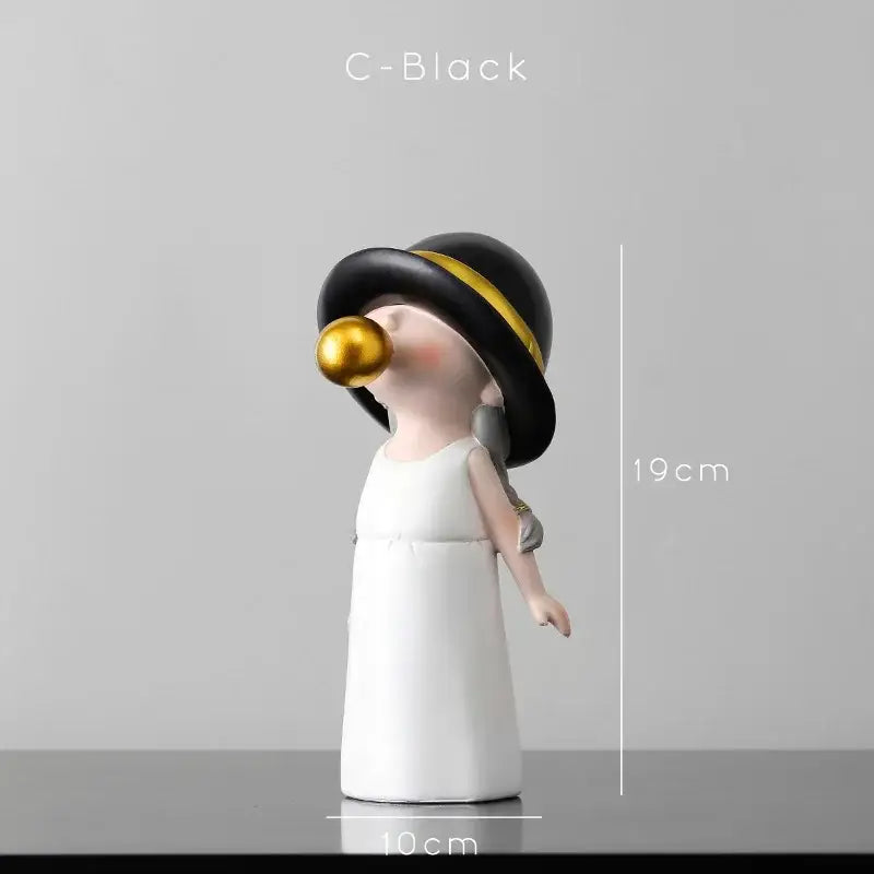 A black and white ceramic bubble gum blowing figurine with a gold band hat for modern living room decor