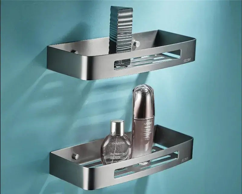 Modern grey bathroom accessories set featuring a brushed stainless steel double-tier towel rack with drainage slots