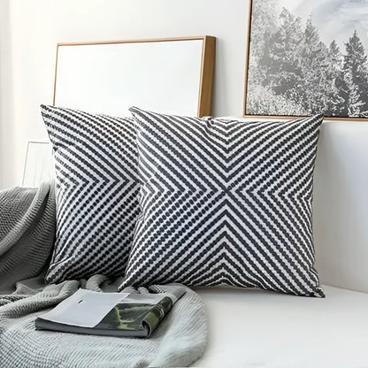 Two gray and white chevron-patterned modern geometric embroidered cushion covers with textured woven fabric for living room decorbites