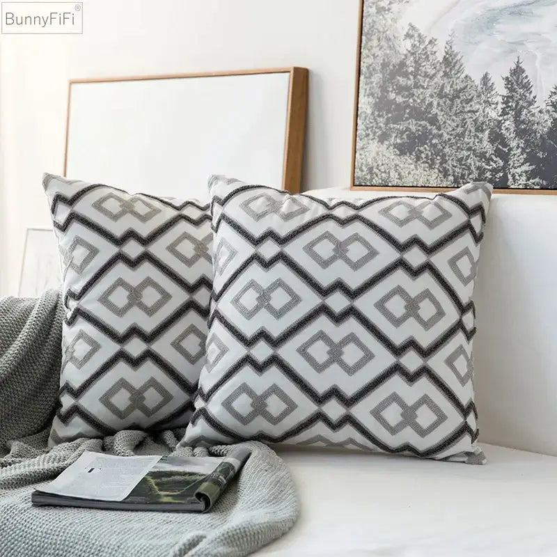 Two matching modern grey geometric embroidered cushion covers with black zigzag and diamond patterns on white fabric for living room decorbites decor