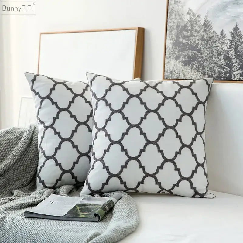 White throw pillows with black quatrefoil pattern featuring soft fabric finish modern grey geometric embroidered cushion cover decorbites