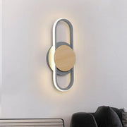 Modern grey and light wood led wall sconce with a sleek circular design featuring an illuminated bedroom ring light