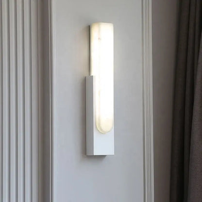 Modern white rectangular wall sconce with frosted glass diffuser emitting warm light for decorbites grey marble led bedside use
