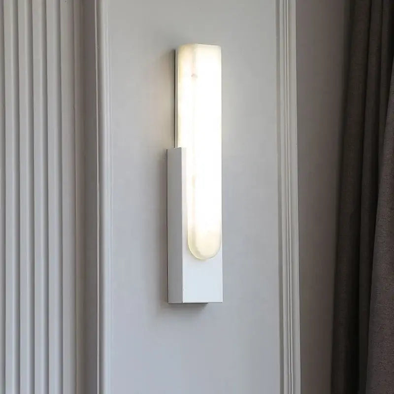 Modern grey marble led wall sconce with white rectangular frosted glass diffuser emitting warm bedside light decorbites grey marble