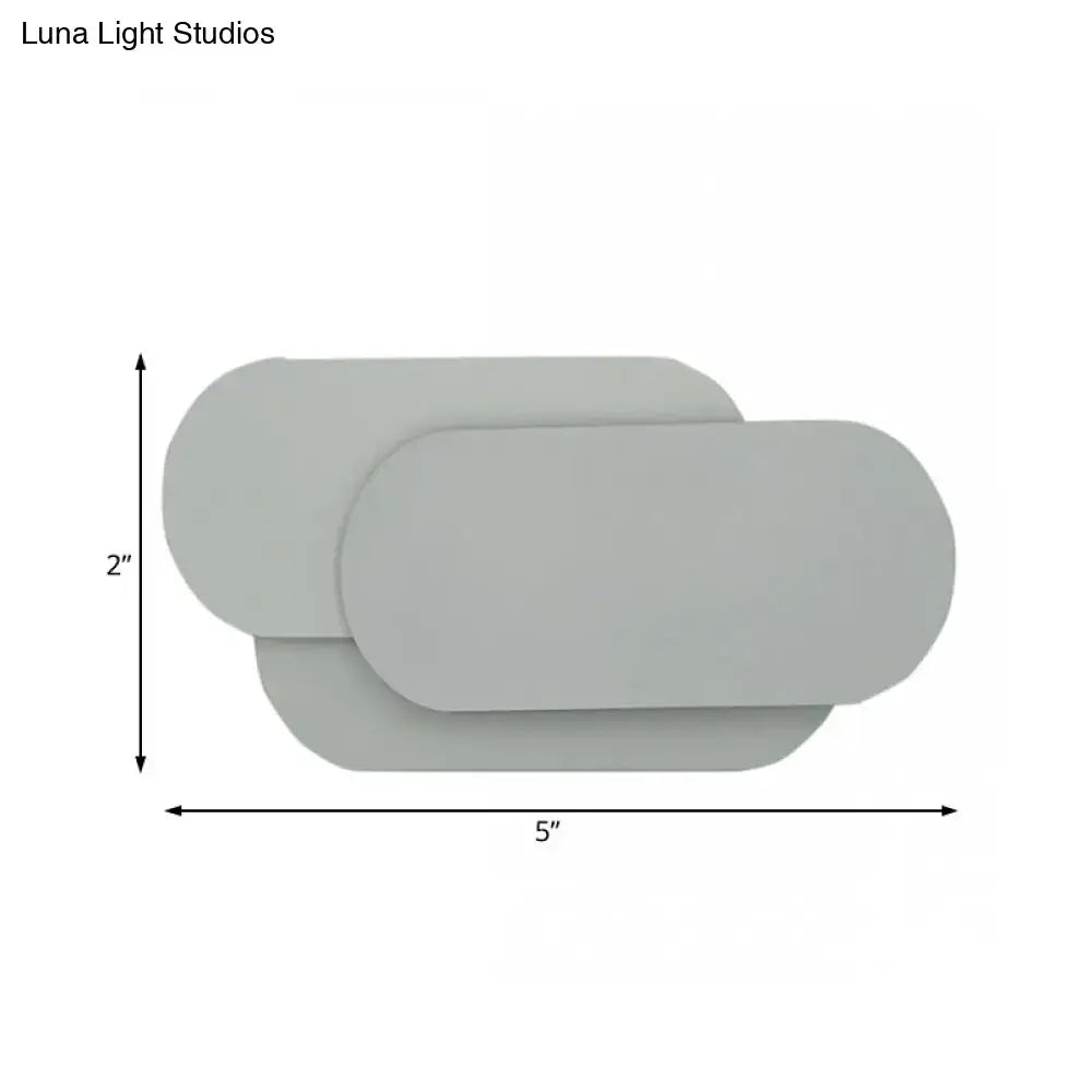 Modern grey oval metal sconce with overlapping panels for bedroom led wall light illumination