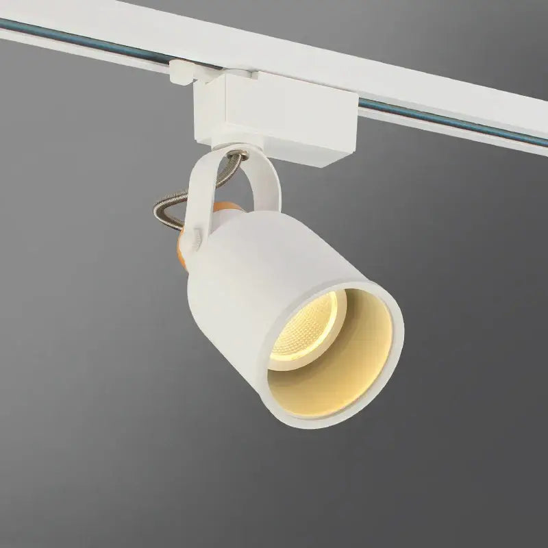 White cylindrical modern gu10 7w led track light with matte finish and gold interior mounted on white rail system