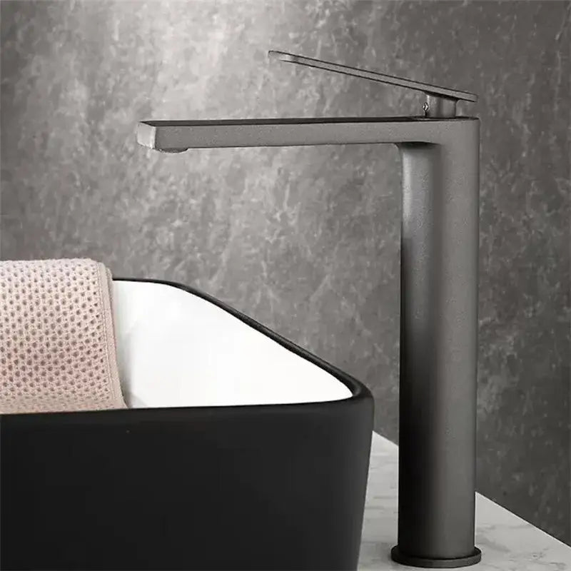 Modern gun gray basin faucet with a sleek minimalist design and tall cylindrical matte black base for bathroom sinks decorbites gun gray