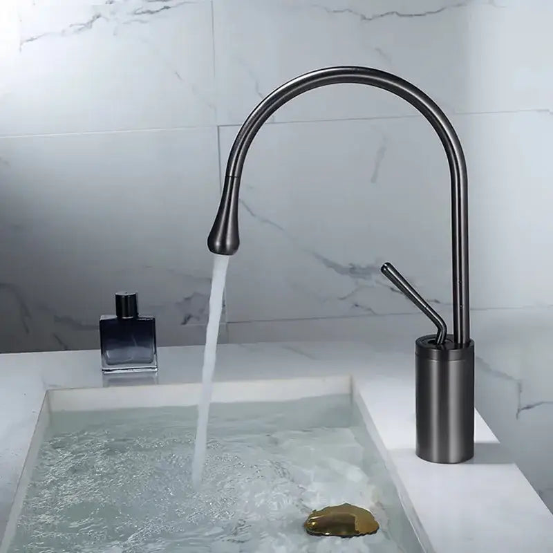Modern gun grey brass basin faucet with a sleek matte black curved spout and cylindrical base for kitchen use decorbites gun grey