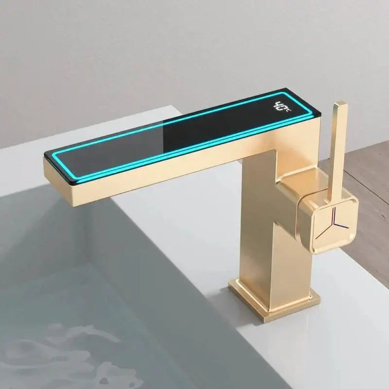 Gold-finished modern gun grey basin faucet with sleek rectangular spout and illuminated 40°c digital display by Decorbites