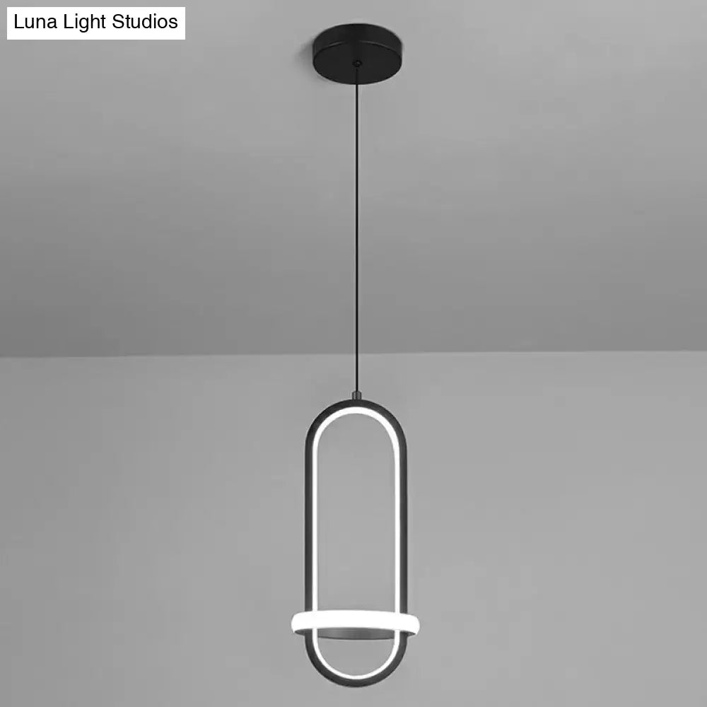 Modern black halo ring bedside pendant light with a sleek minimalist design featuring an illuminated oval frame and circular accents