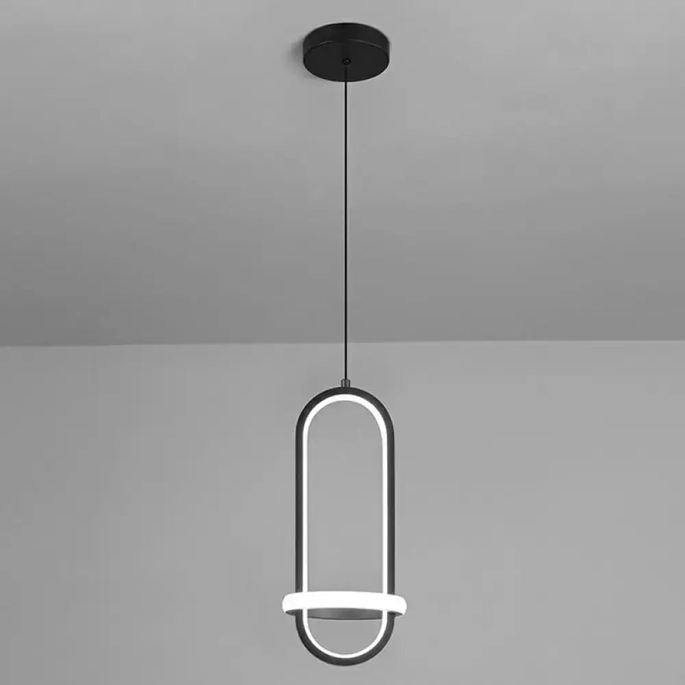Modern black bedside pendant light with a minimalist halo ring design featuring an illuminated oval frame and circular accents