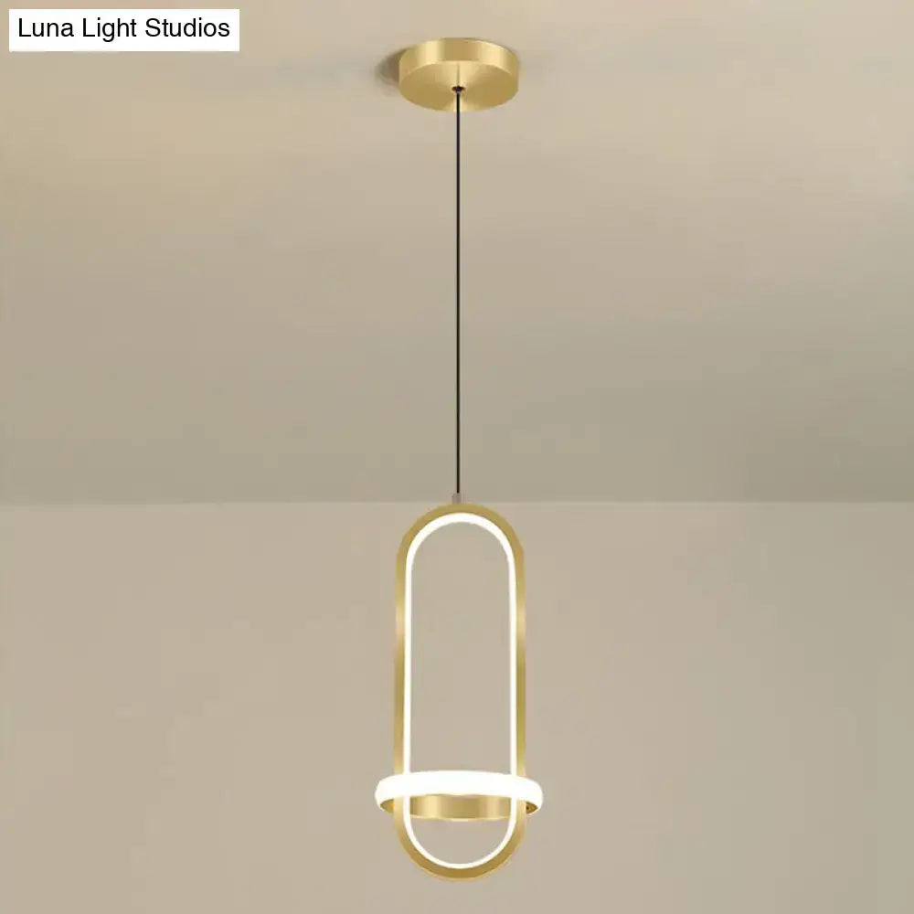 Gold-finished modern halo ring bedside pendant light with illuminated oval frame and circular base for bedroom use