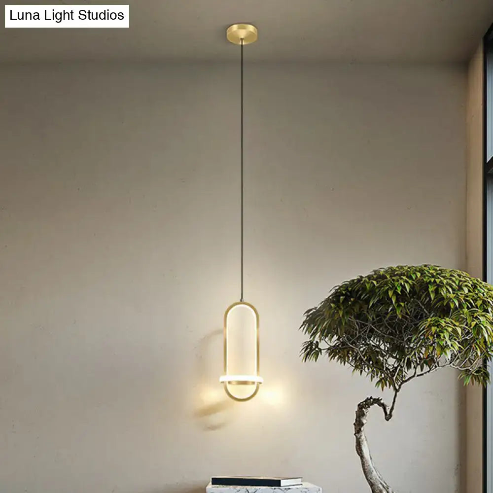 Modern halo ring bedside pendant light with gold-toned minimalist oval frame and warm ambient glow for bedroom use