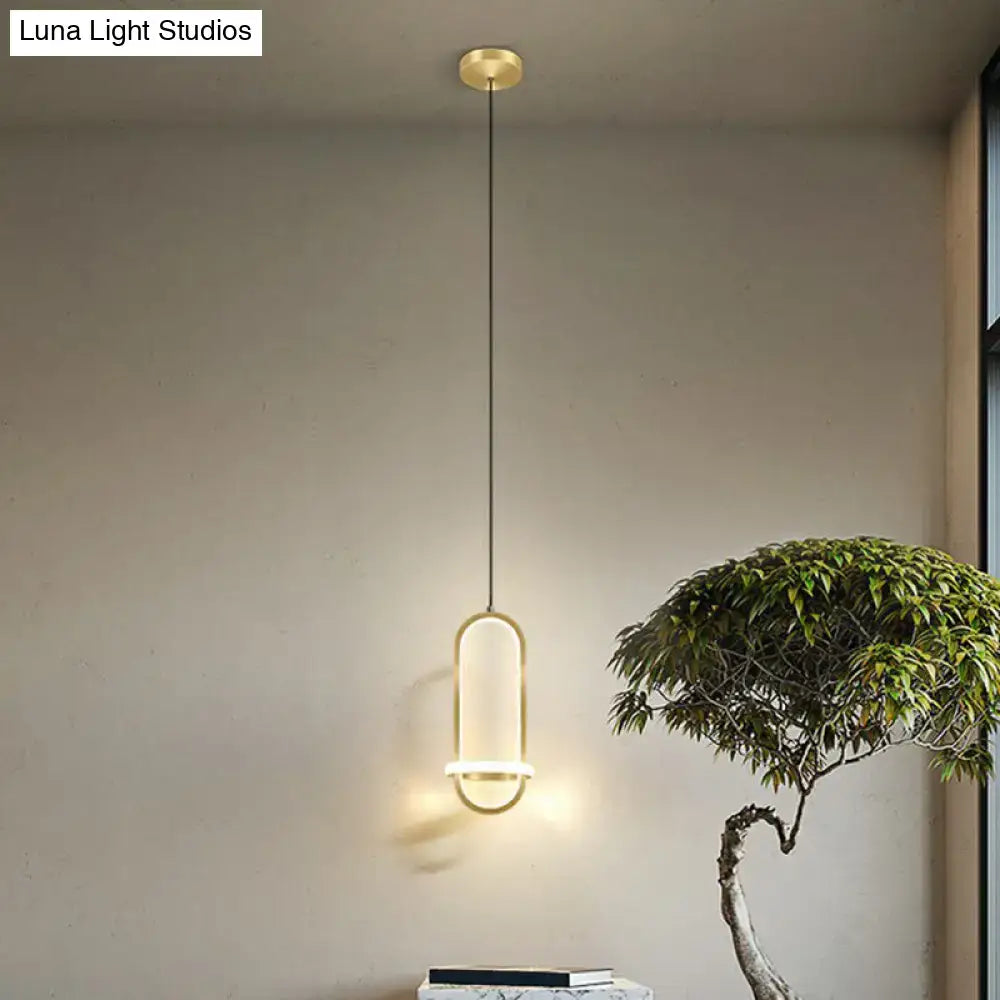 Gold-toned modern halo ring bedside pendant light with sleek oval design and warm ambient glow for bedroom lighting