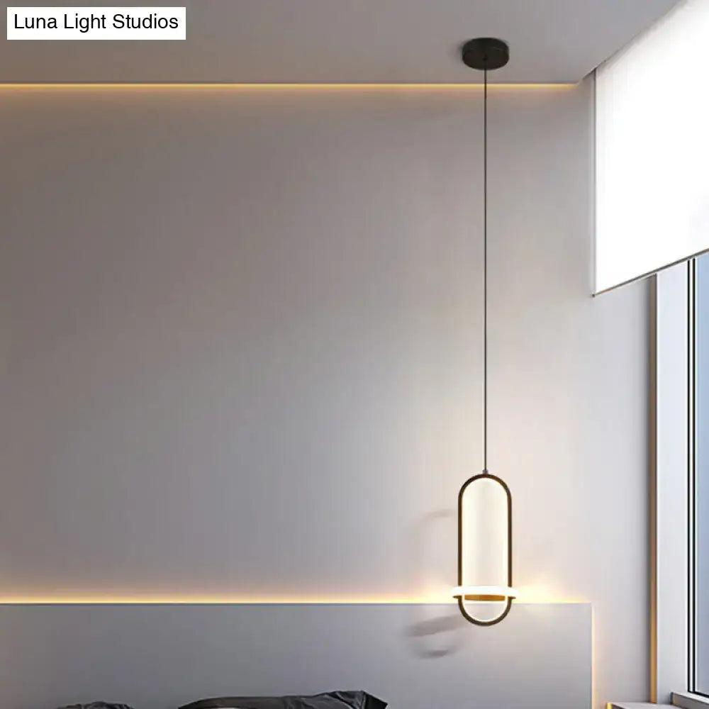 Modern halo ring bedside pendant light with sleek black metal frame and warm diffused led glow for bedroom use