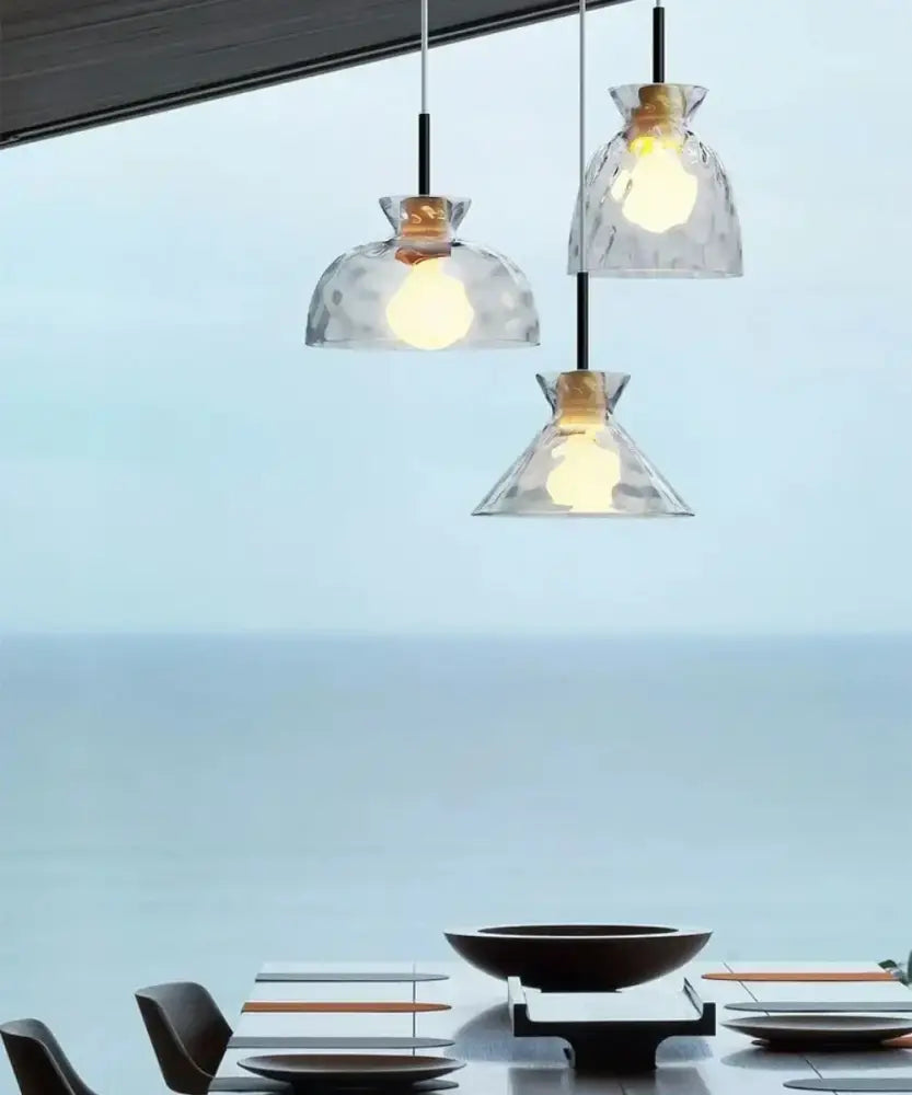 Modern hammered clear glass pendant lamp with textured clear glass shades and warm metal fixtures for kitchen decorbites clear glass