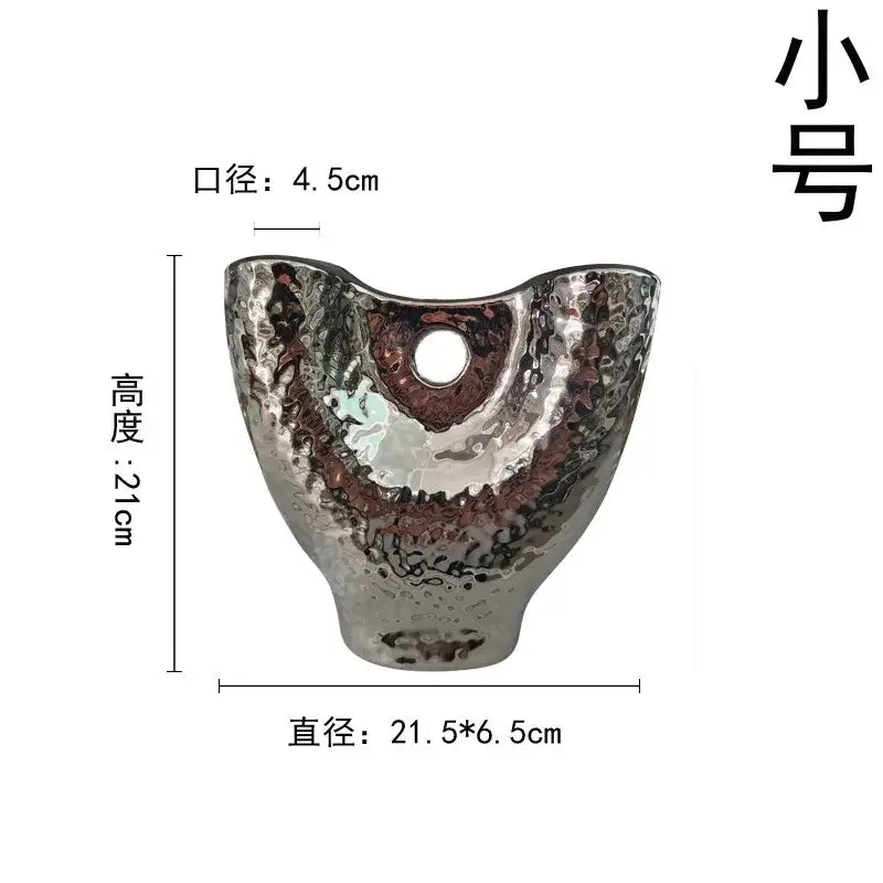 A small modern hammered silver ceramic vase with textured surface and central opening from decorbites gold vase set