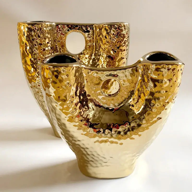 Modern hammered gold vase by decorbites featuring a textured ceramic surface and dual circular openings for living room decor