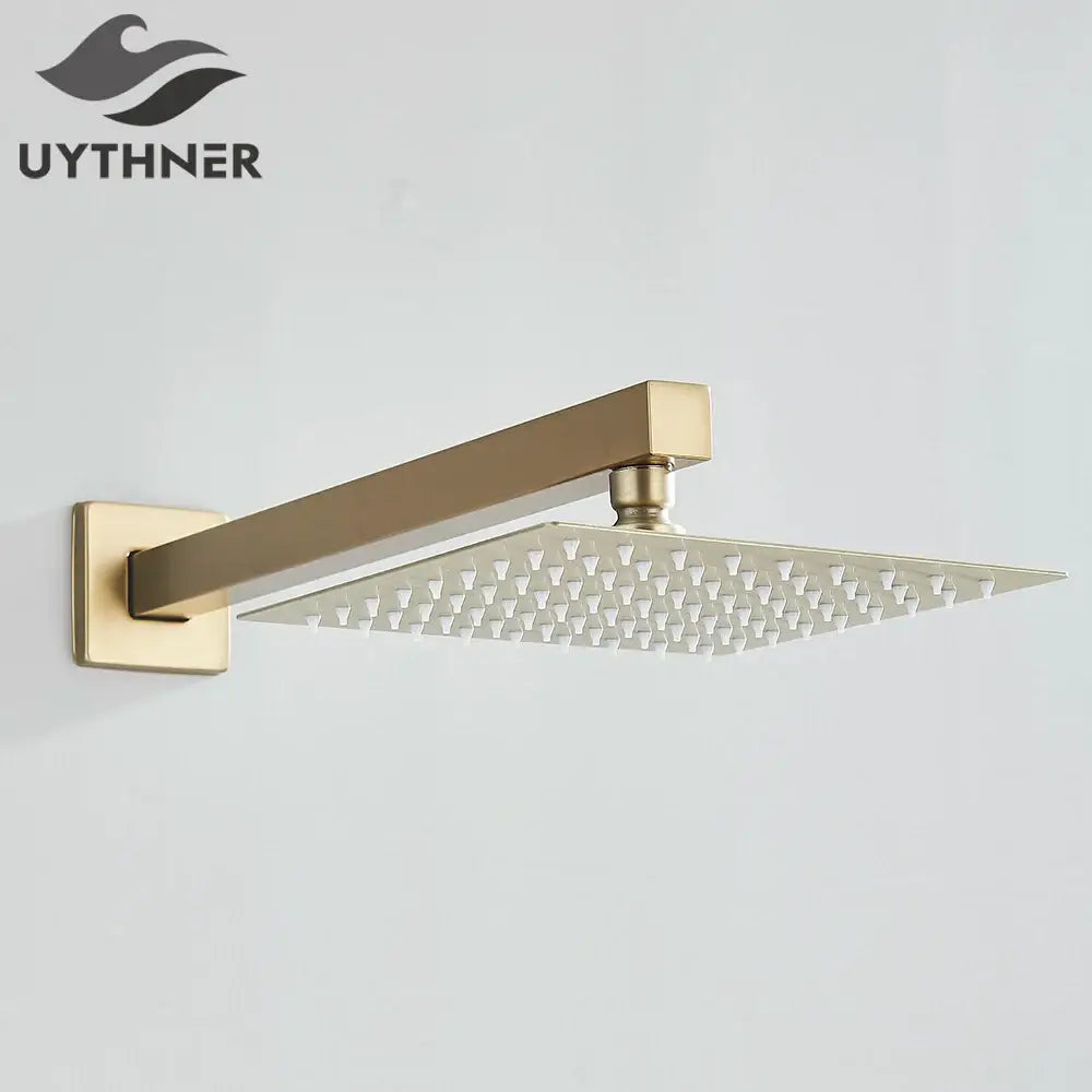 Modern hammered gold-finished rectangular wall mounted shower head with sleek design and grid of small nozzles