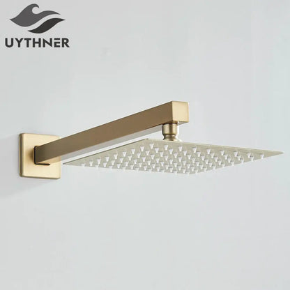 Modern hammered gold-finished rectangular wall mounted shower head with sleek design and grid of small nozzles