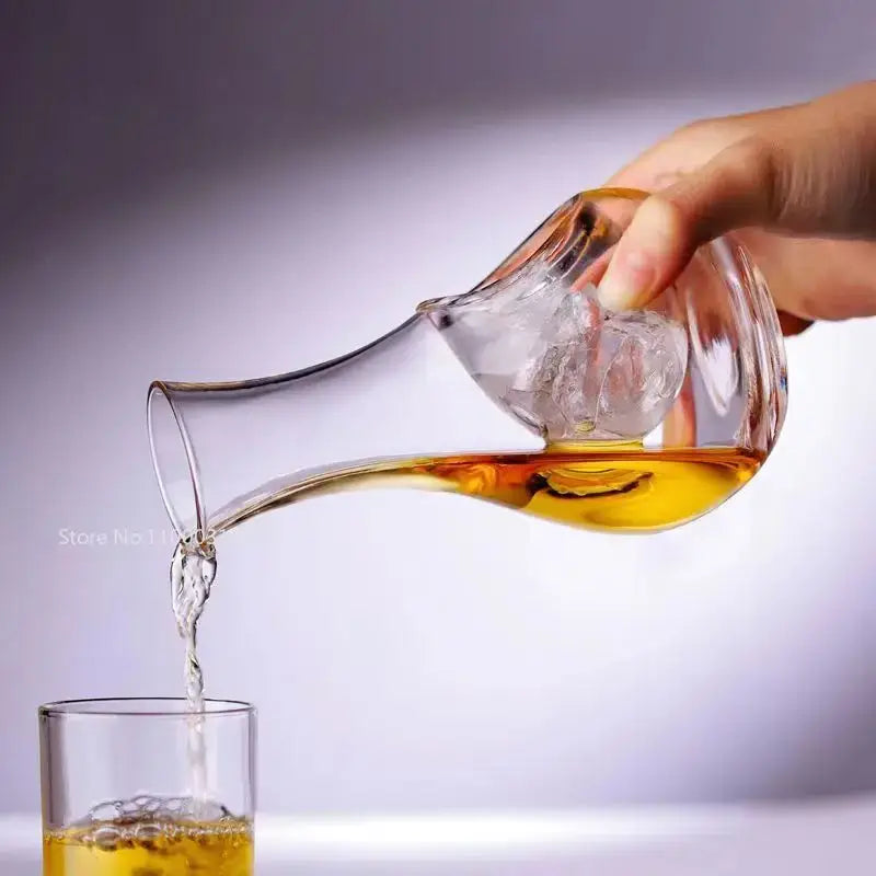 Modern hamster nest crystal glass wine decanter set features a clear glass wine decanter with amber liquid and ice cubes