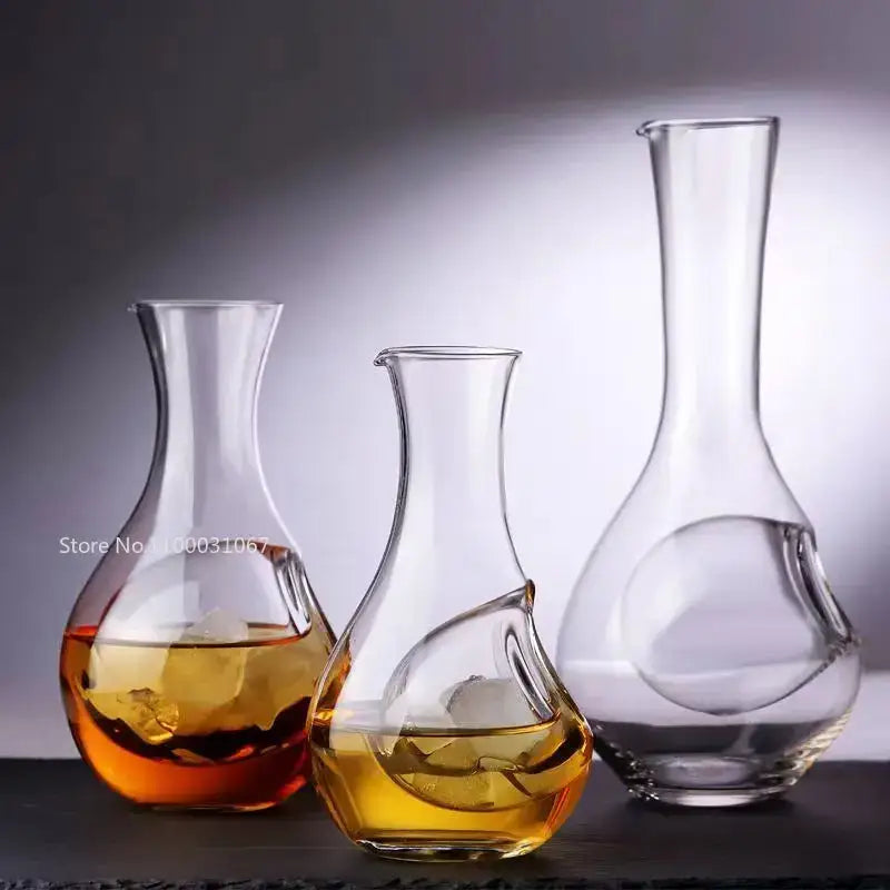 Three clear decorbites crystal glass wine decanters with sculpted handles in varying heights for modern dining room decor