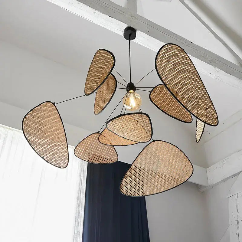 Modern hand made rattan pendant chandelier with beige woven design and black leaf-shaped panels for living room lighting