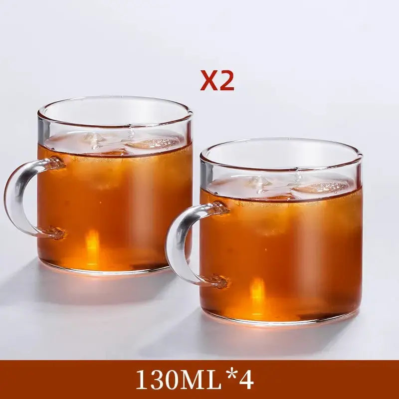 Modern heat resistant clear glass tea cup set with handle filled with iced tea for dining room use