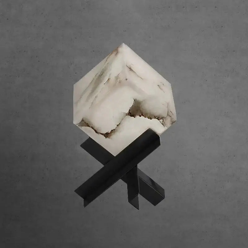 Modern hexagonal cube marble table lamp in white with natural veining on a black metal x-shaped base for bedroom decorbites cube marble table lamp