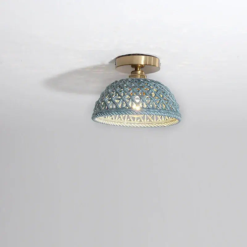 A light blue woven rattan dome ceiling light with brass base complementing decorbites ceramic led ceiling lights